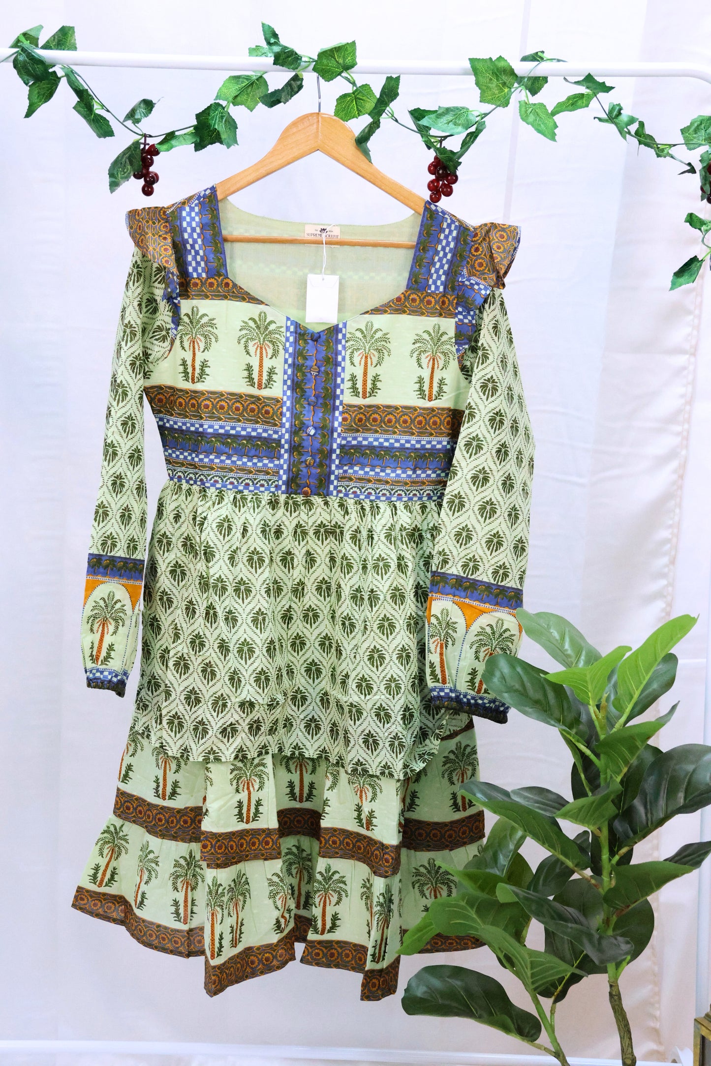 Green blockprinted dress on hanger