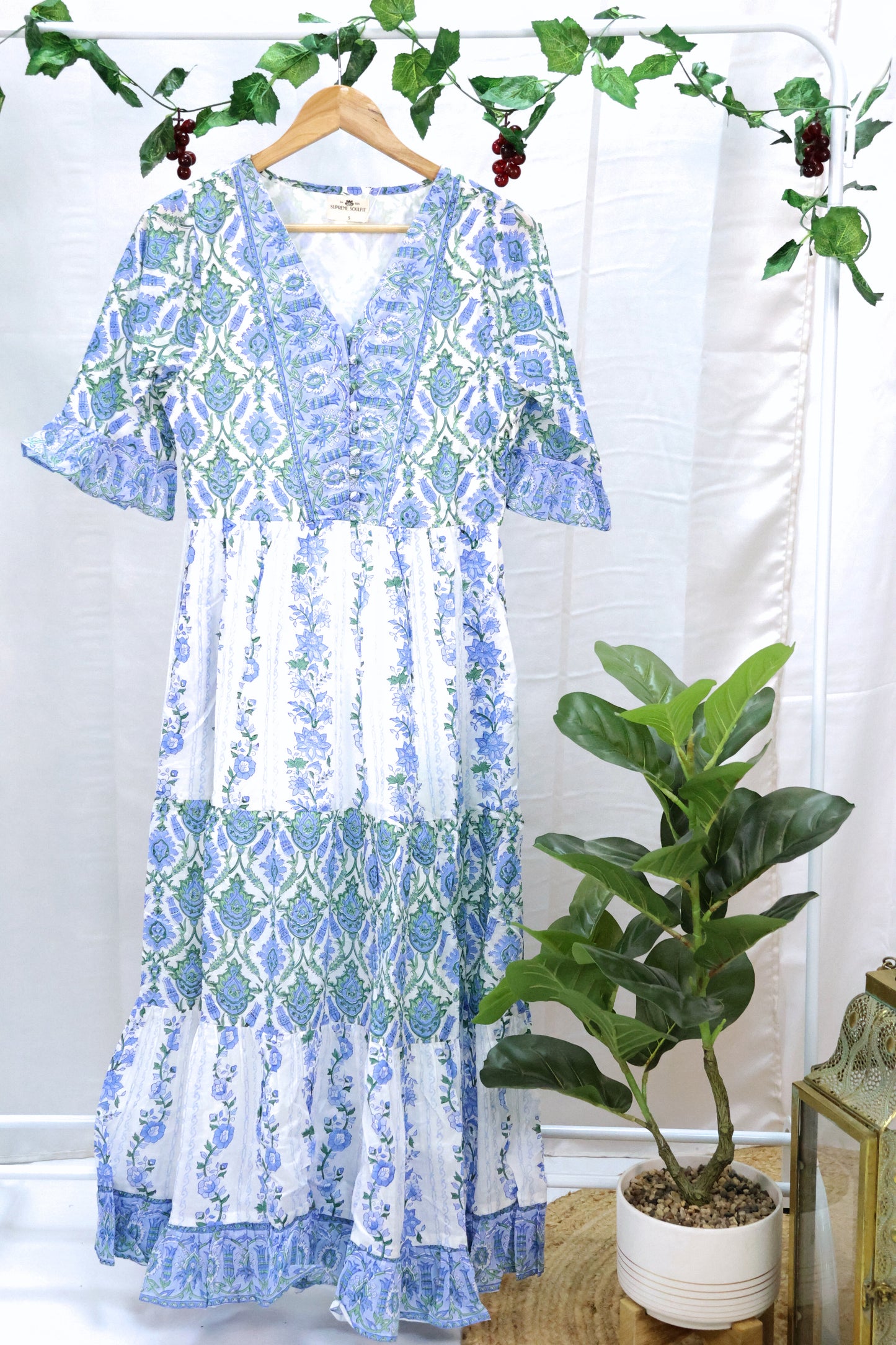 peacock blue floor length blockprint dress with half sleeves on a hanger.
