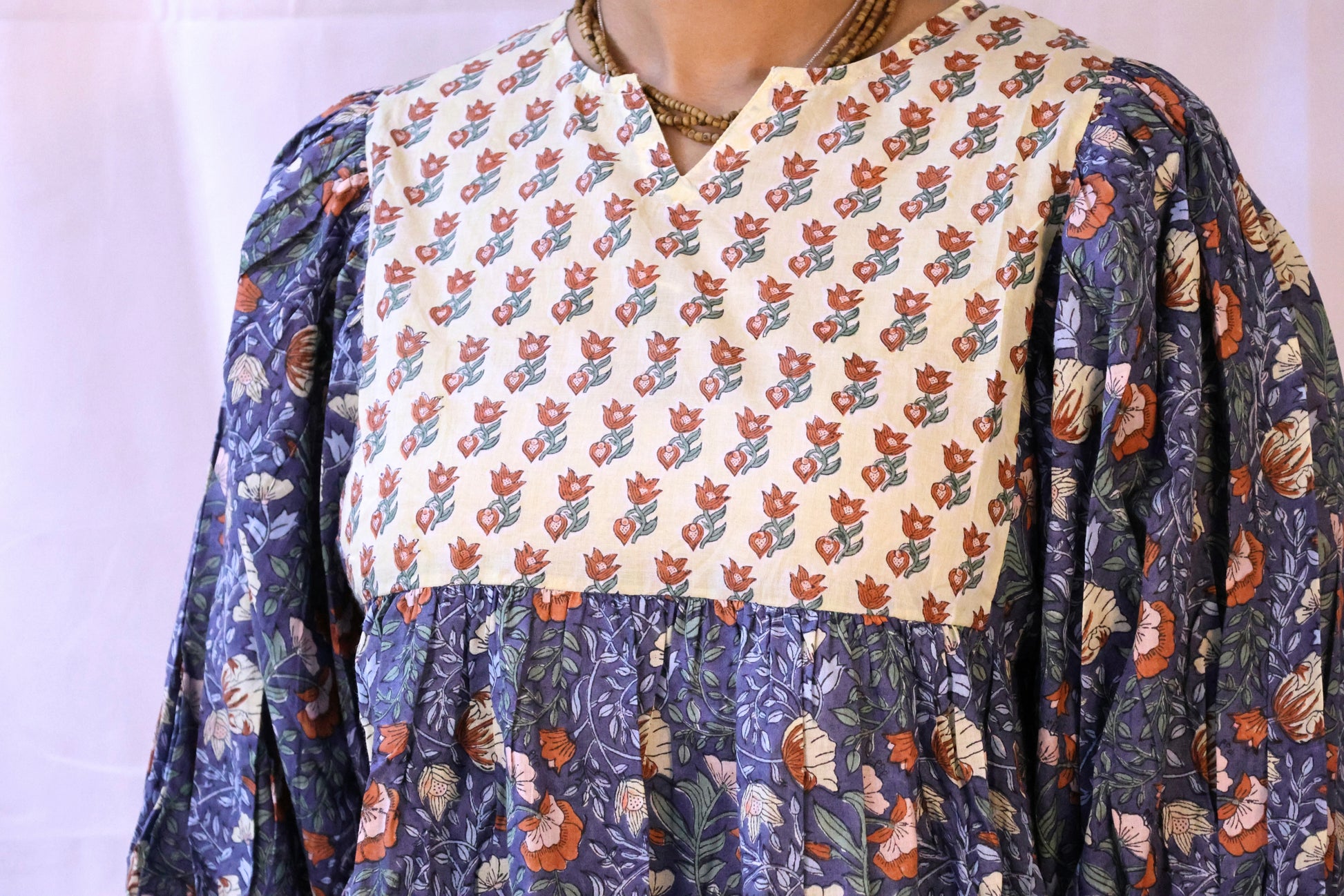 Blue bohemian top with puffy sleeves and hand blockprinted patterns closeup.