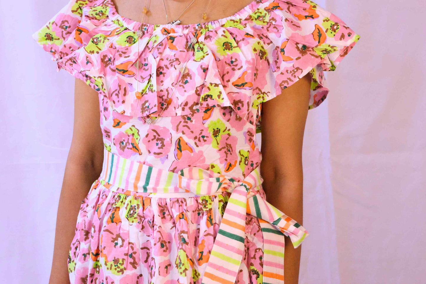 Close up of pink floral off-shoulder blockprint dress